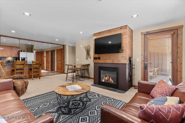 834 Mckinley Ave Unit 208, Kellogg, ID 83837 - living area with light carpet, recessed lighting, a large fireplace, and baseboards
