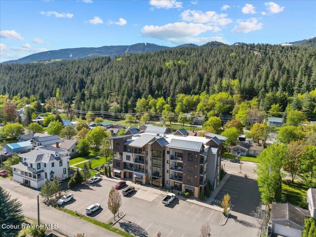 834 Mckinley Ave Unit 208, Kellogg, ID 83837 - drone / aerial view of a forest and a mountain backdrop