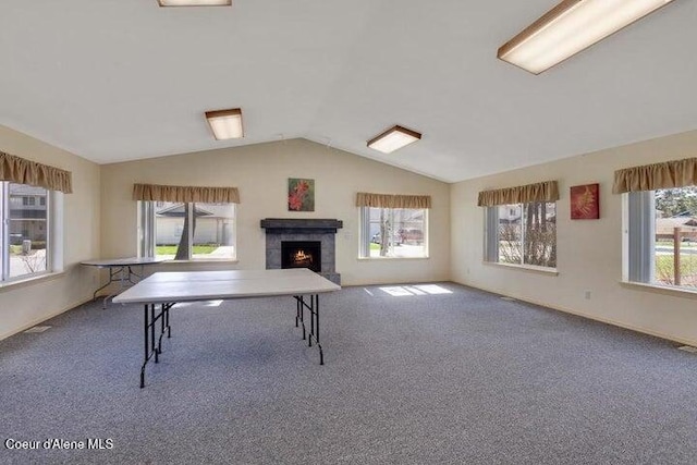 368 E Whispering Pines Ln # 6, Coeur Dalene, ID 83815 - rec room with baseboards, carpet, vaulted ceiling, and a lit fireplace
