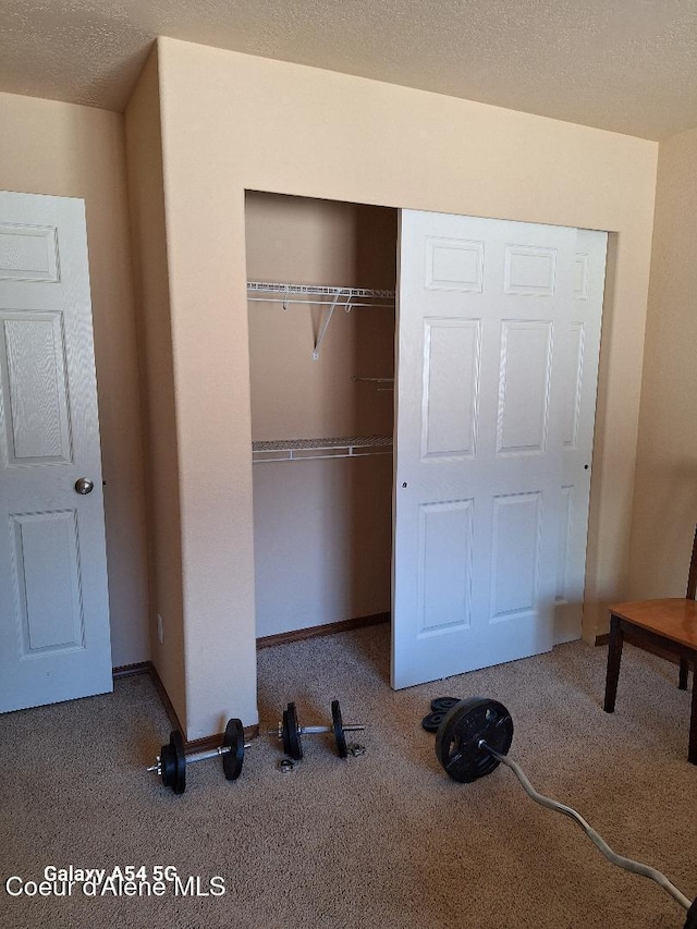 368 E Whispering Pines Ln # 6, Coeur Dalene, ID 83815 - unfurnished bedroom featuring a closet, carpet flooring, and baseboards