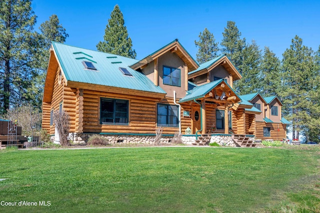 log home with a front lawn, log siding, and metal roof