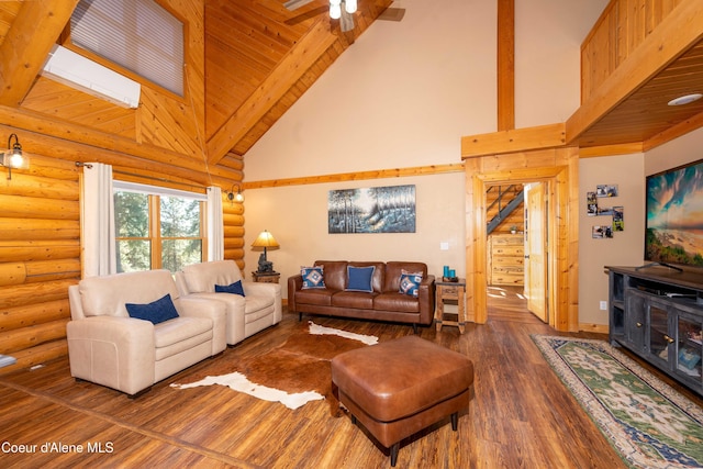 living room featuring wood finished floors, a ceiling fan, high vaulted ceiling, beamed ceiling, and rustic walls