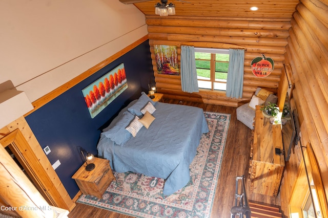 bedroom featuring rustic walls, recessed lighting, and wood finished floors