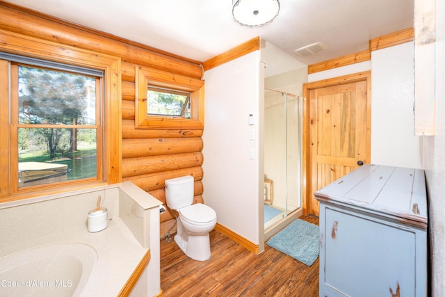 bathroom featuring a stall shower, toilet, rustic walls, visible vents, and wood finished floors