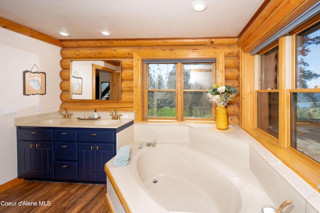 bathroom with a sink, rustic walls, a bath, and wood finished floors