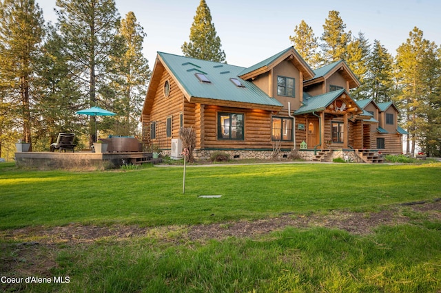view of front facade featuring a front yard, log exterior, and metal roof