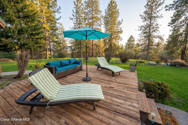 deck featuring an outdoor hangout area and a yard