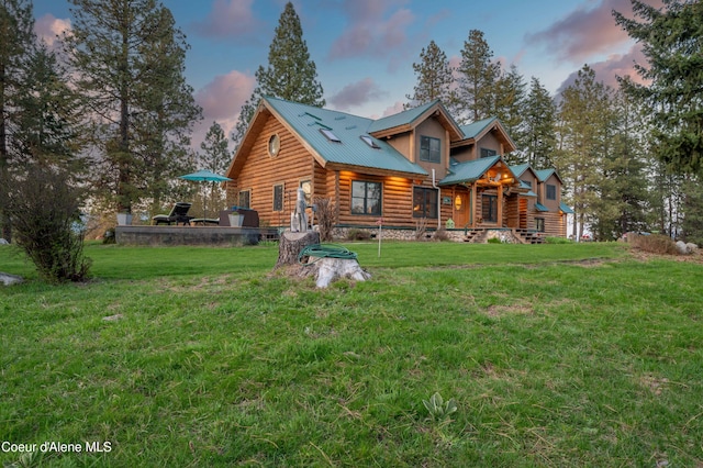 log home with a lawn, log exterior, and metal roof