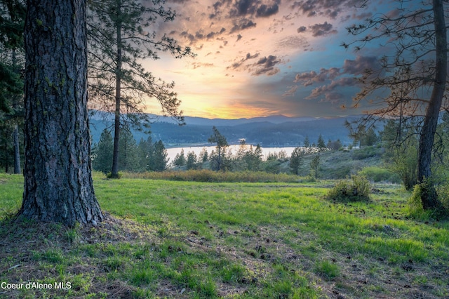 exterior space with a water and mountain view