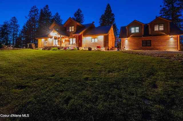 log cabin featuring a yard and log exterior
