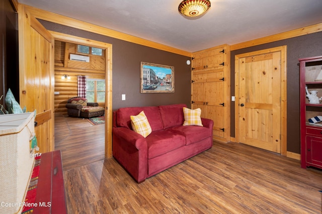 living area featuring log walls and wood finished floors