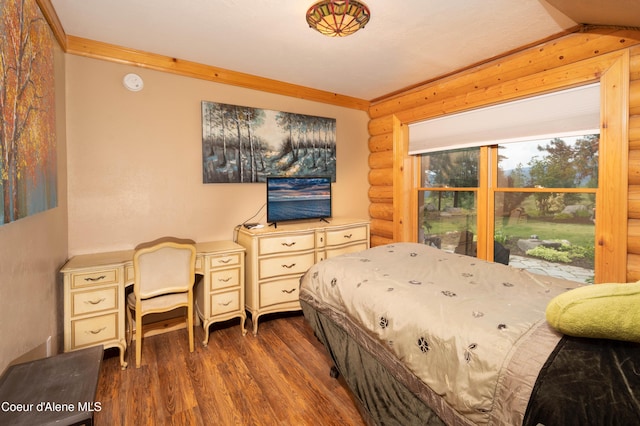 bedroom with vaulted ceiling, ornamental molding, rustic walls, and wood finished floors