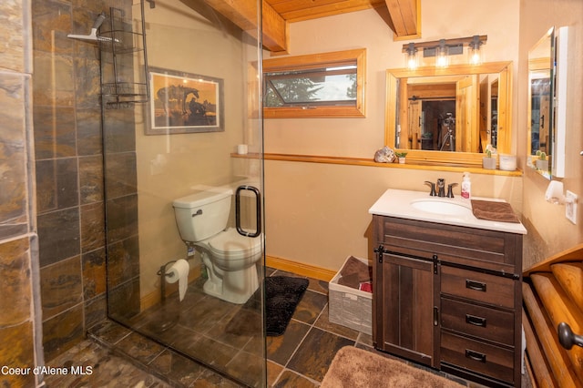 bathroom featuring vanity, toilet, tile patterned flooring, and a tile shower