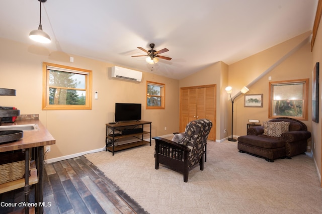 living area featuring a ceiling fan, vaulted ceiling, a wall mounted air conditioner, baseboards, and wood finished floors