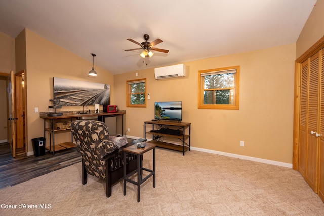 interior space with a ceiling fan, vaulted ceiling, baseboards, and an AC wall unit