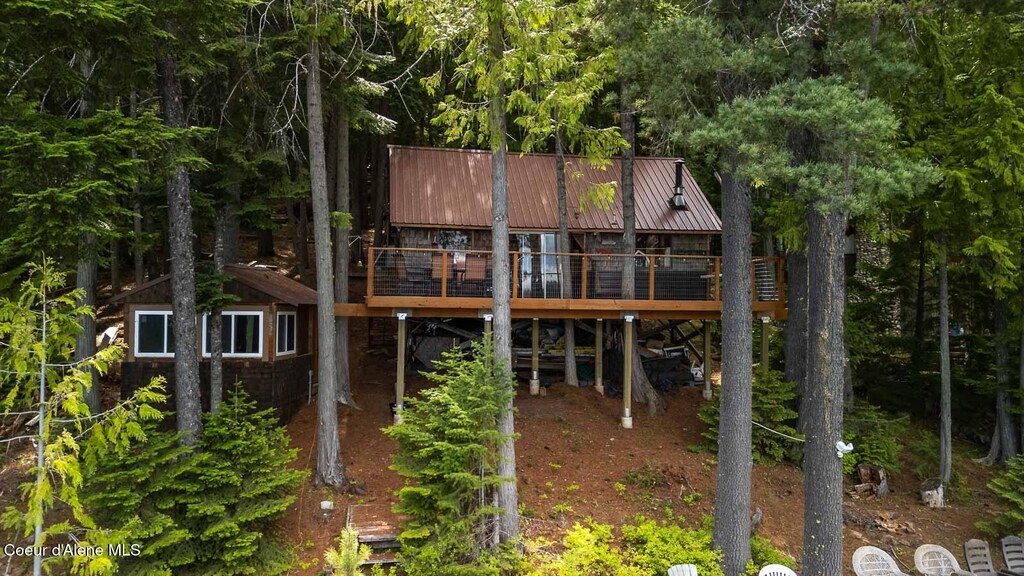 15994 S Spirit Lake Shr, Spirit Lake, ID 83869 - back of property featuring a deck and metal roof