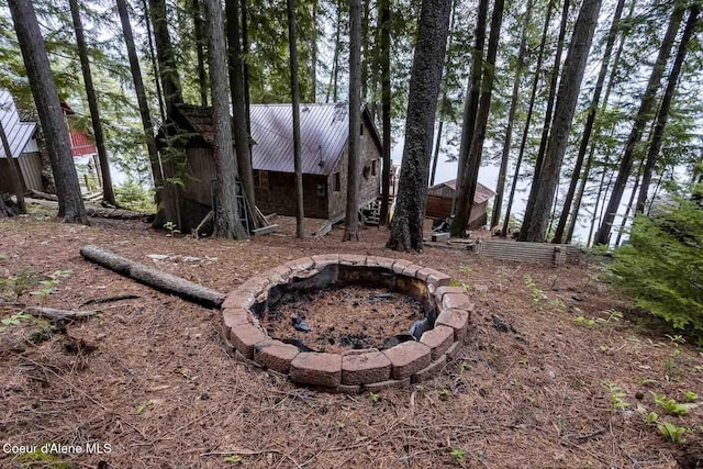 view of yard with an outdoor fire pit