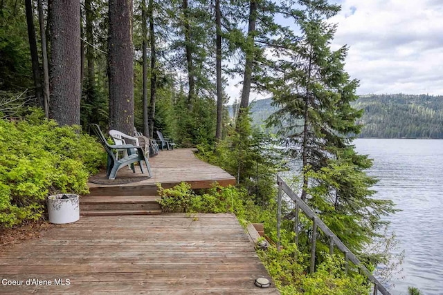 exterior space with a wooded view and a water view