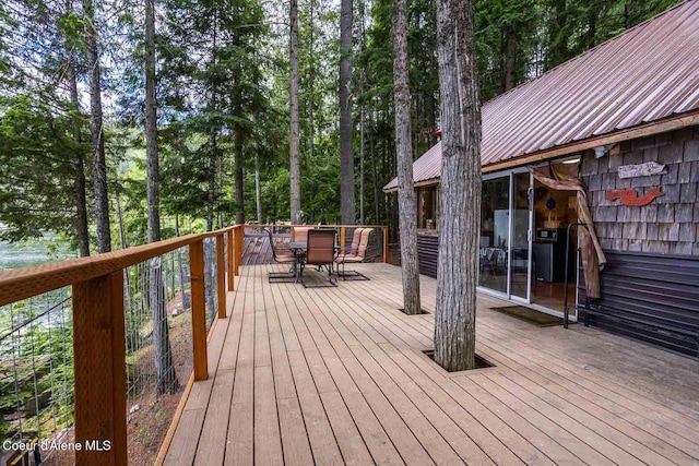 wooden terrace with outdoor dining area