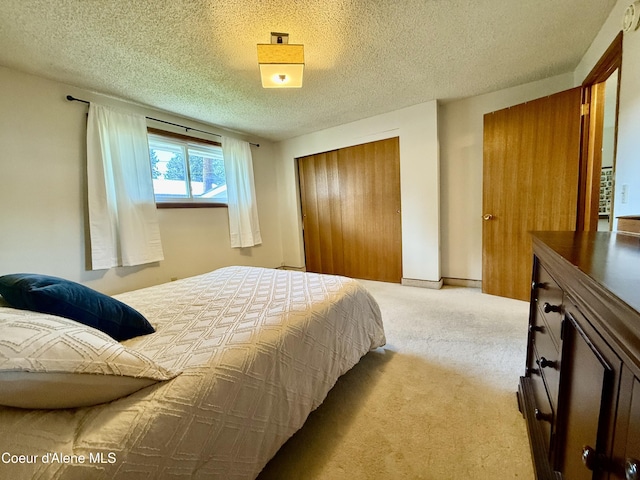 bedroom with carpet, a closet, and a textured ceiling