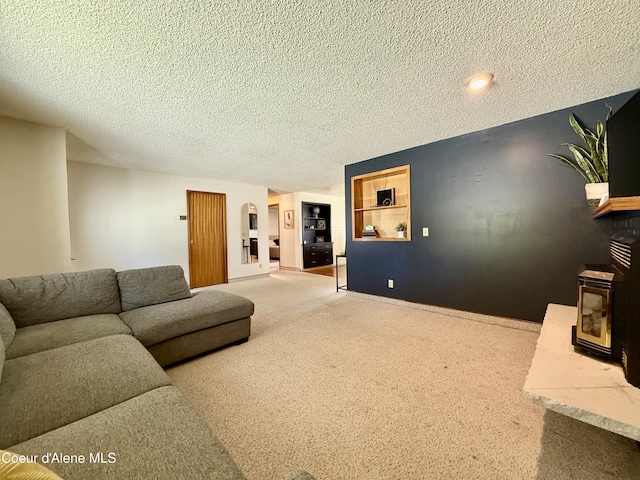 carpeted living room with arched walkways, baseboards, and a textured ceiling