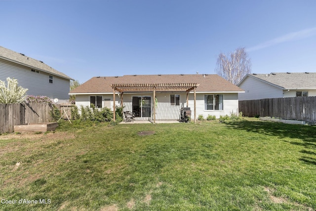 back of house featuring a lawn, a pergola, a shingled roof, and a fenced backyard