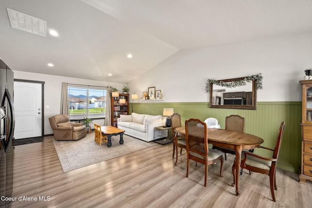 dining area featuring visible vents, wainscoting, recessed lighting, light wood-type flooring, and vaulted ceiling