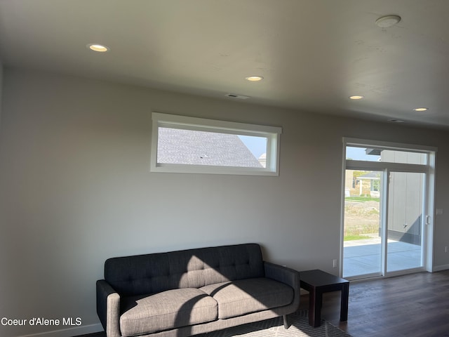 living room featuring dark wood-style flooring, recessed lighting, and baseboards