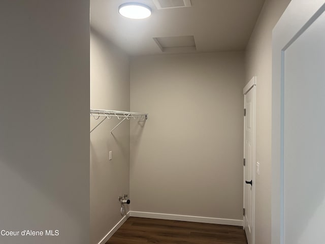 laundry area with baseboards, laundry area, attic access, and dark wood-type flooring
