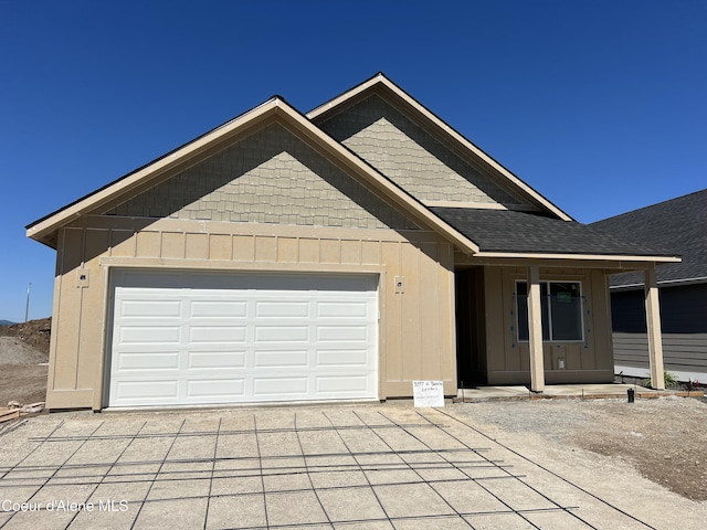 3397 N Blaze Loop, Post Falls, ID 83854 - view of front of property featuring driveway, an attached garage, and a shingled roof
