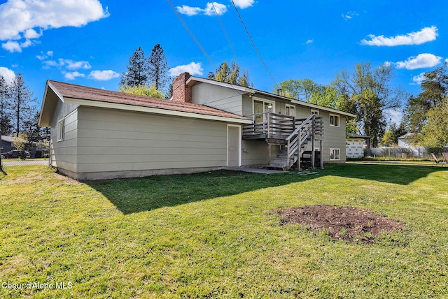 407 E Buttercup Ln, Coeur Dalene, ID 83815 - rear view of house with a chimney, a lawn, a deck, stairway, and fence