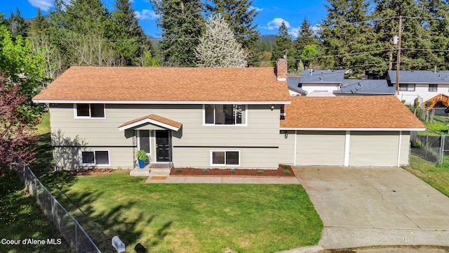 407 E Buttercup Ln, Coeur Dalene, ID 83815 - raised ranch with a front lawn, fence, a chimney, a shingled roof, and concrete driveway