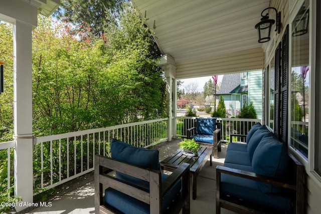 deck with an outdoor hangout area and a porch