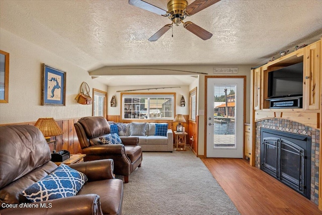 34128 N Scenic Bay D Dock Unit 21, Bayview, ID 83803 - living room with a fireplace, a textured ceiling, wood finished floors, and a wainscoted wall