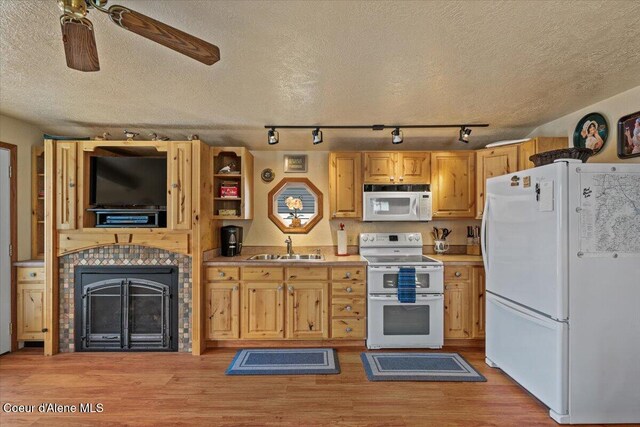 34128 N Scenic Bay D Dock Unit 21, Bayview, ID 83803 - kitchen featuring rail lighting, a sink, light countertops, light wood finished floors, and white appliances