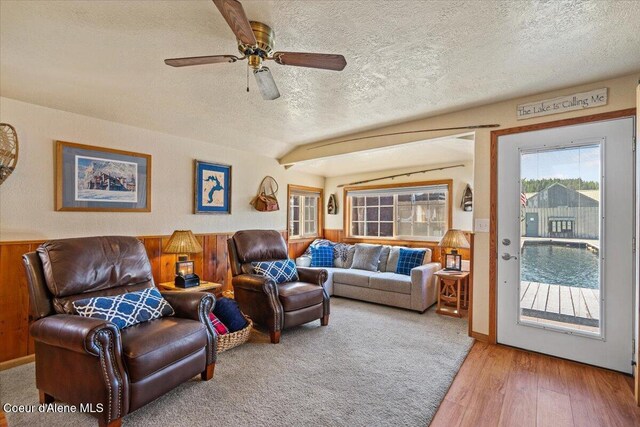 34128 N Scenic Bay D Dock Unit 21, Bayview, ID 83803 - living area featuring a ceiling fan, a textured ceiling, wainscoting, and wood finished floors