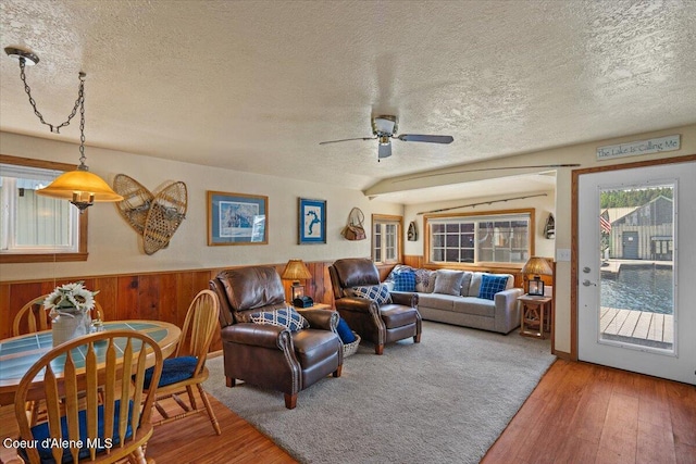 34128 N Scenic Bay D Dock Unit 21, Bayview, ID 83803 - living area featuring a textured ceiling, wood walls, ceiling fan, and hardwood / wood-style flooring