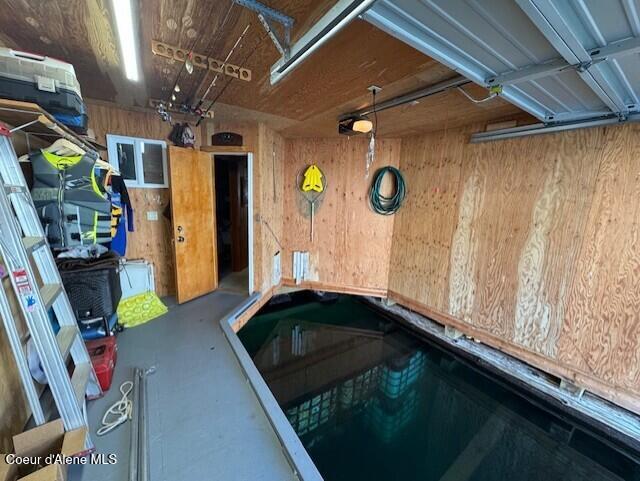 34128 N Scenic Bay D Dock Unit 21, Bayview, ID 83803 - garage featuring wood walls and a garage door opener