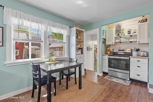 kitchen with white cabinetry, open shelves, stainless steel range with electric cooktop, dark wood-type flooring, and light countertops