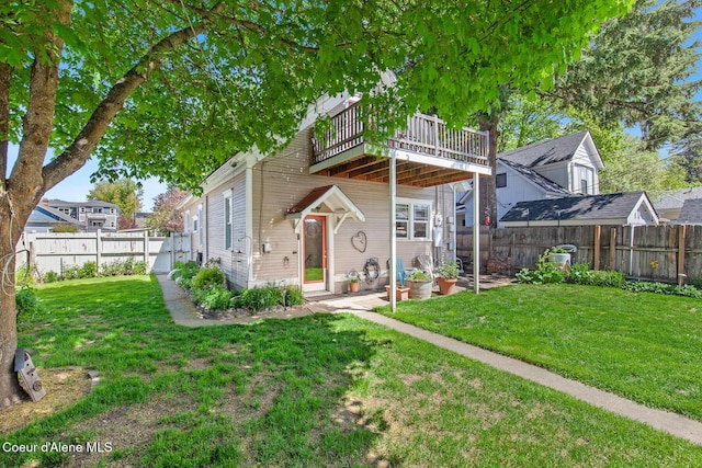 exterior space with a yard, a deck, and a fenced backyard