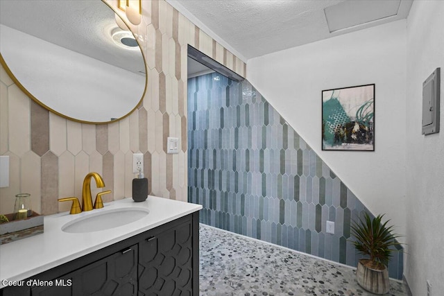 503 N 2nd St, Coeur Dalene, ID 83814 - full bathroom with electric panel, a textured ceiling, and vanity
