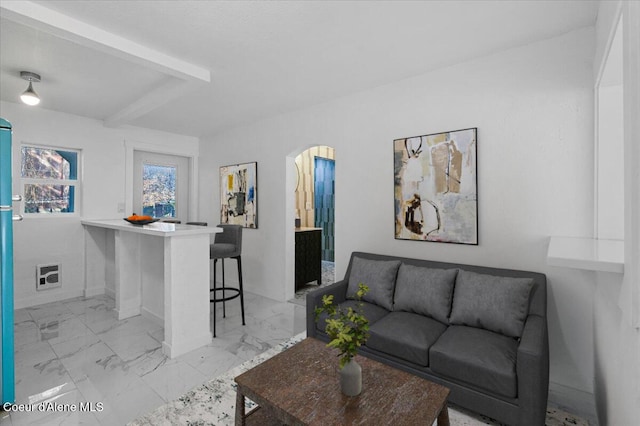 503 N 2nd St, Coeur Dalene, ID 83814 - living room with arched walkways, marble finish floor, baseboards, and beamed ceiling