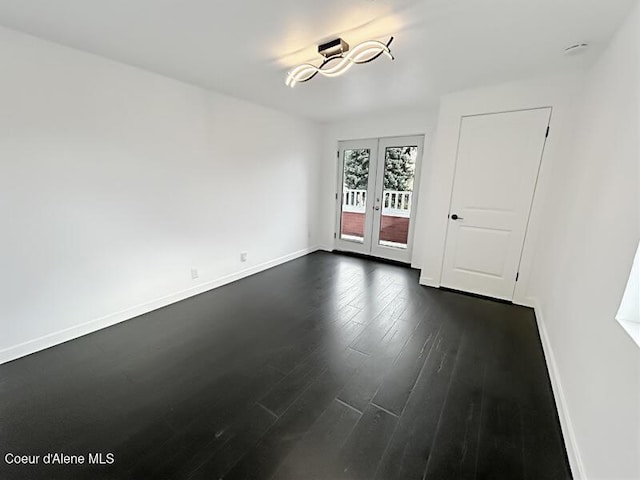 503 N 2nd St, Coeur Dalene, ID 83814 - spare room with dark wood-style flooring, baseboards, french doors, and a chandelier