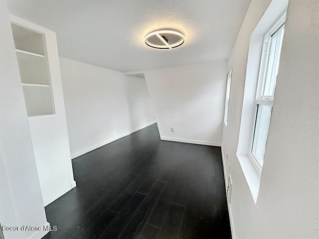 503 N 2nd St, Coeur Dalene, ID 83814 - unfurnished room featuring baseboards, plenty of natural light, and dark wood-style floors