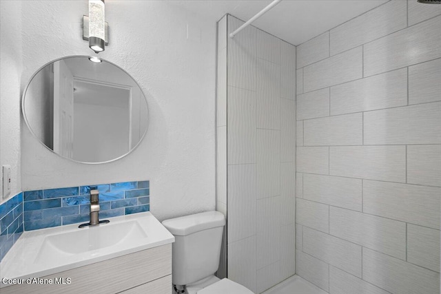 503 N 2nd St, Coeur Dalene, ID 83814 - bathroom featuring toilet, tiled shower, and vanity