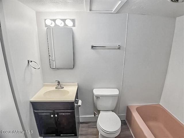 1422 E Young Ave, Coeur Dalene, ID 83814 - bathroom with toilet, baseboards, vanity, and wood finished floors