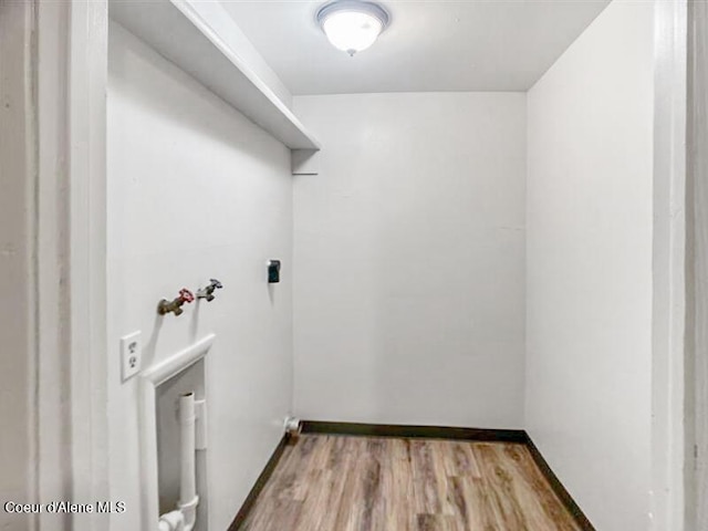 1422 E Young Ave, Coeur Dalene, ID 83814 - clothes washing area with baseboards, washer hookup, wood finished floors, hookup for an electric dryer, and laundry area