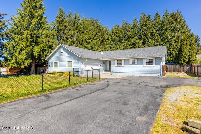 1547 E Stratford Dr, Hayden, ID 83835 - single story home featuring aphalt driveway, fence, a garage, and a front lawn