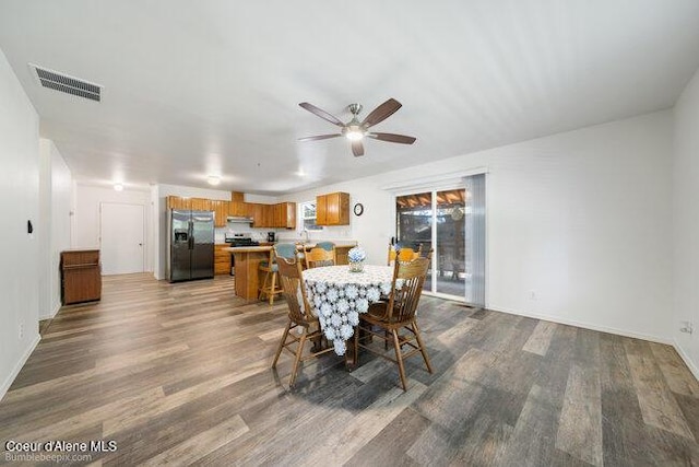 1547 E Stratford Dr, Hayden, ID 83835 - dining room featuring ceiling fan, baseboards, dark wood-style floors, and visible vents