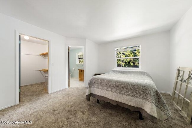 1547 E Stratford Dr, Hayden, ID 83835 - carpeted bedroom featuring a spacious closet and connected bathroom